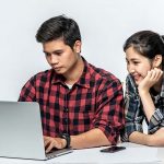 2 People Looking into Computer Screen